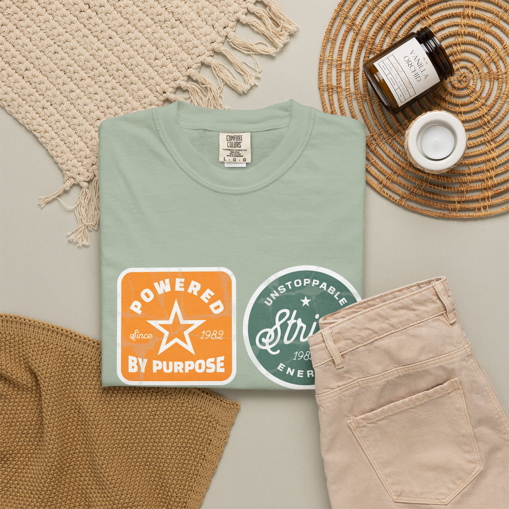 Motivational Badge T-Shirt — "Powered by Purpose / Strive / Journey / Freedom"